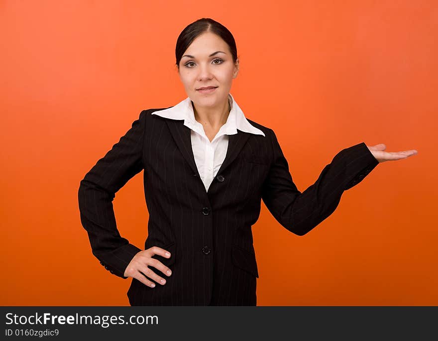 Attractive brunette businesswoman. Over orange background