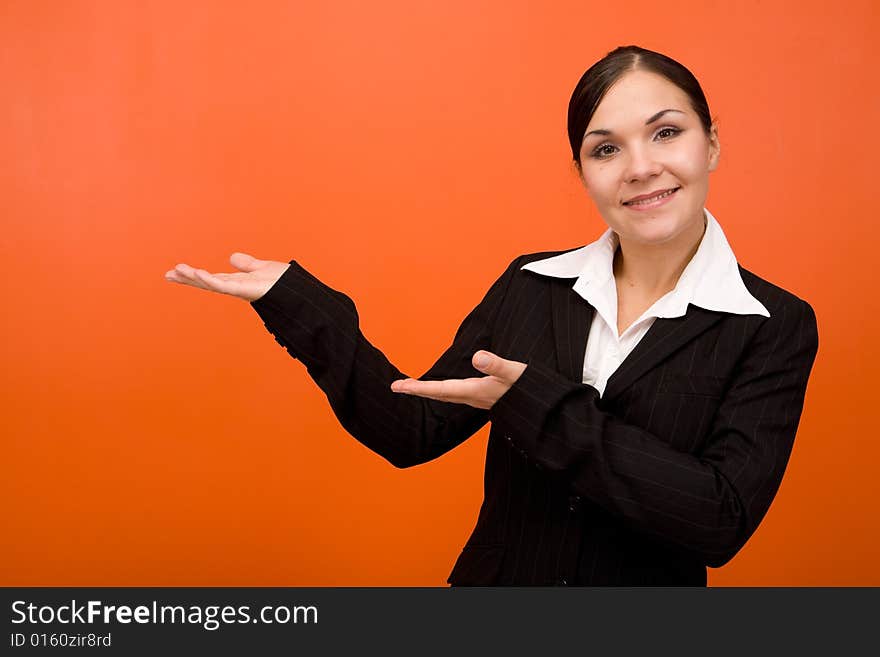 Attractive brunette businesswoman. Over orange background