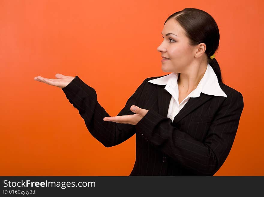 Attractive brunette businesswoman. Over orange background