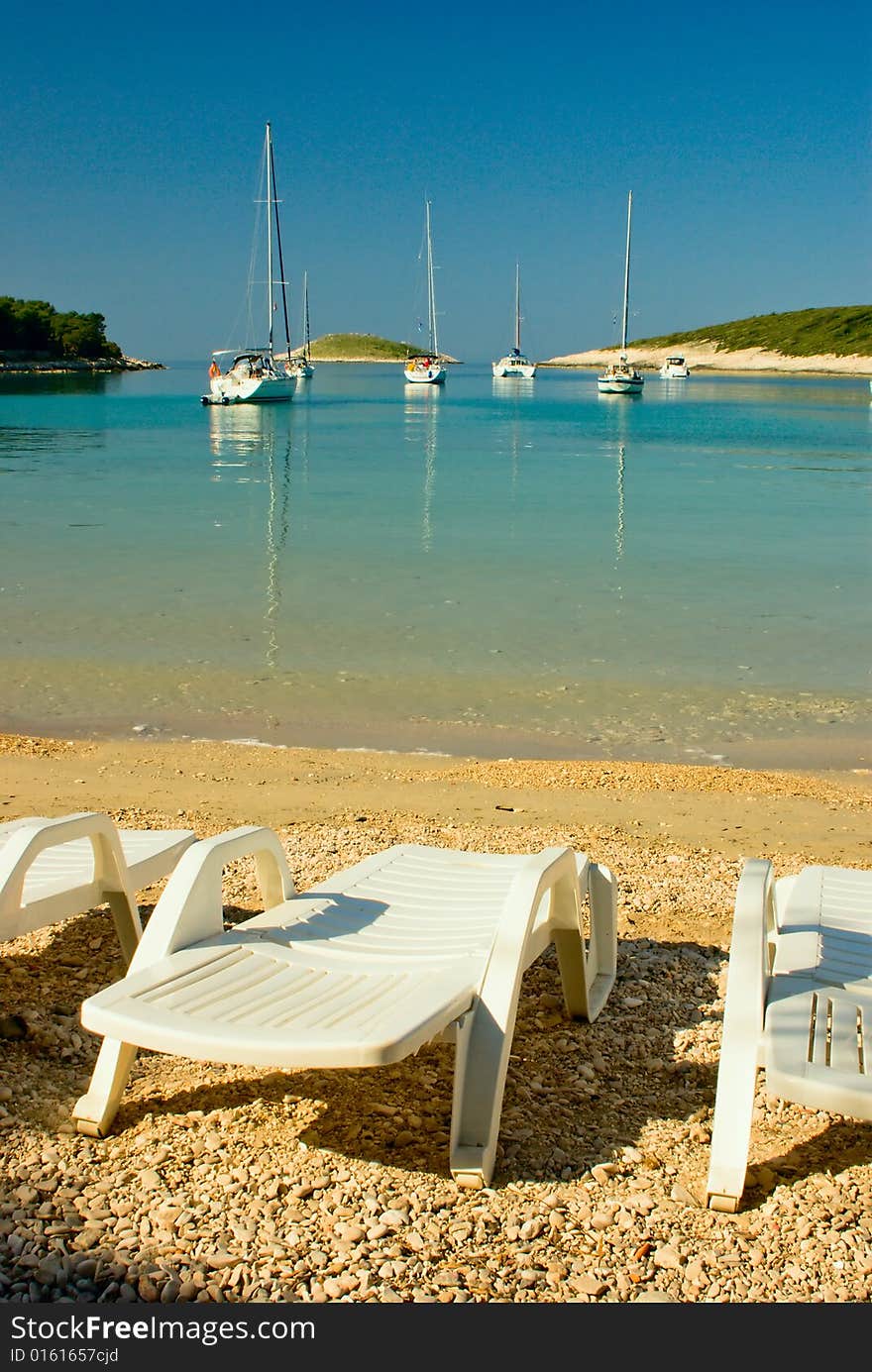 Beach sun lounger near sea lagoon of yachting club near hvar, croatia