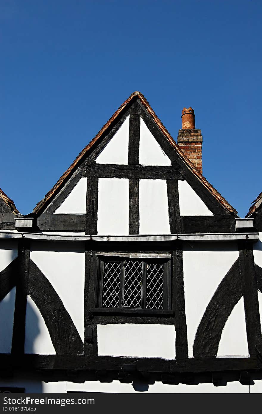 A medieval, Tudorian building with a blue sky in the background. A medieval, Tudorian building with a blue sky in the background.