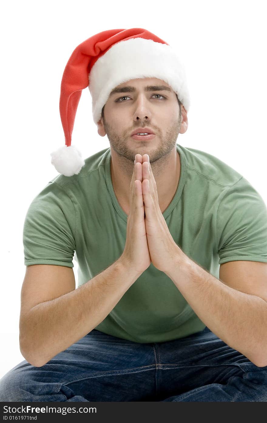 Praying man with santa cap on an isolated background