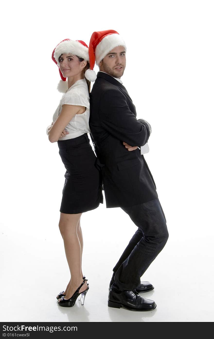 Smiling couple posing with santa cap on an isolated white background