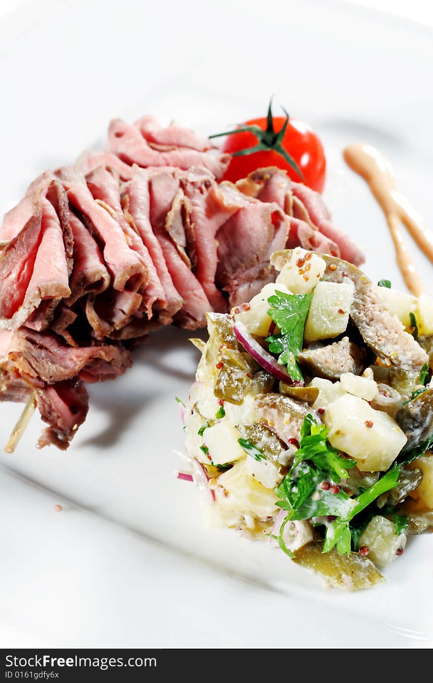 Roast Beef Served with Salad (Potatoes and Vegetables) and Cherry Tomato. Isolated on White Background