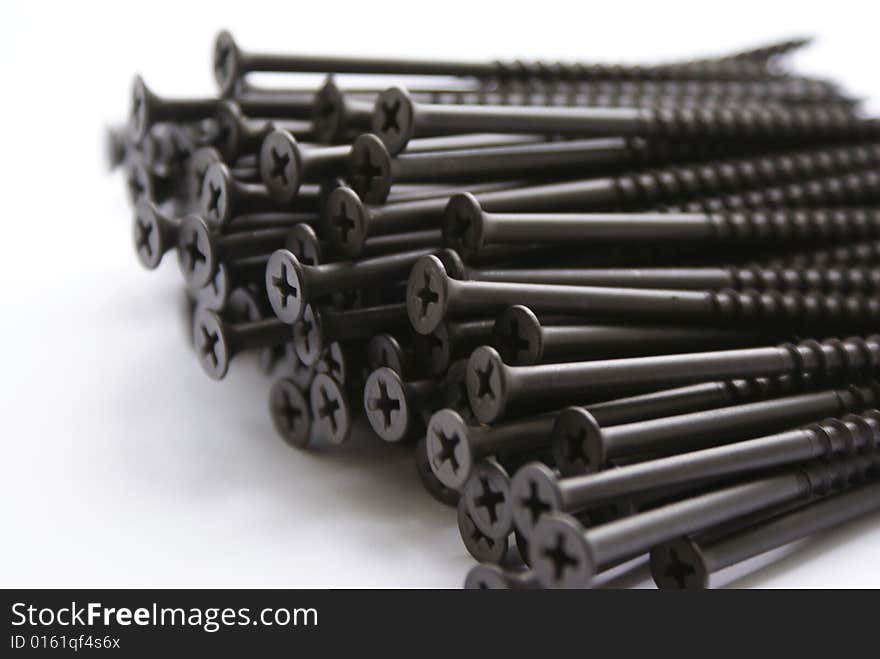 Sundries. Group of iron screws on a white background