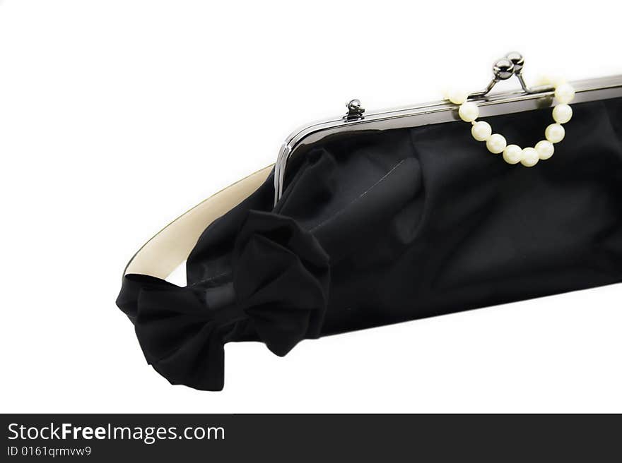 Black bag and pearl bracelet