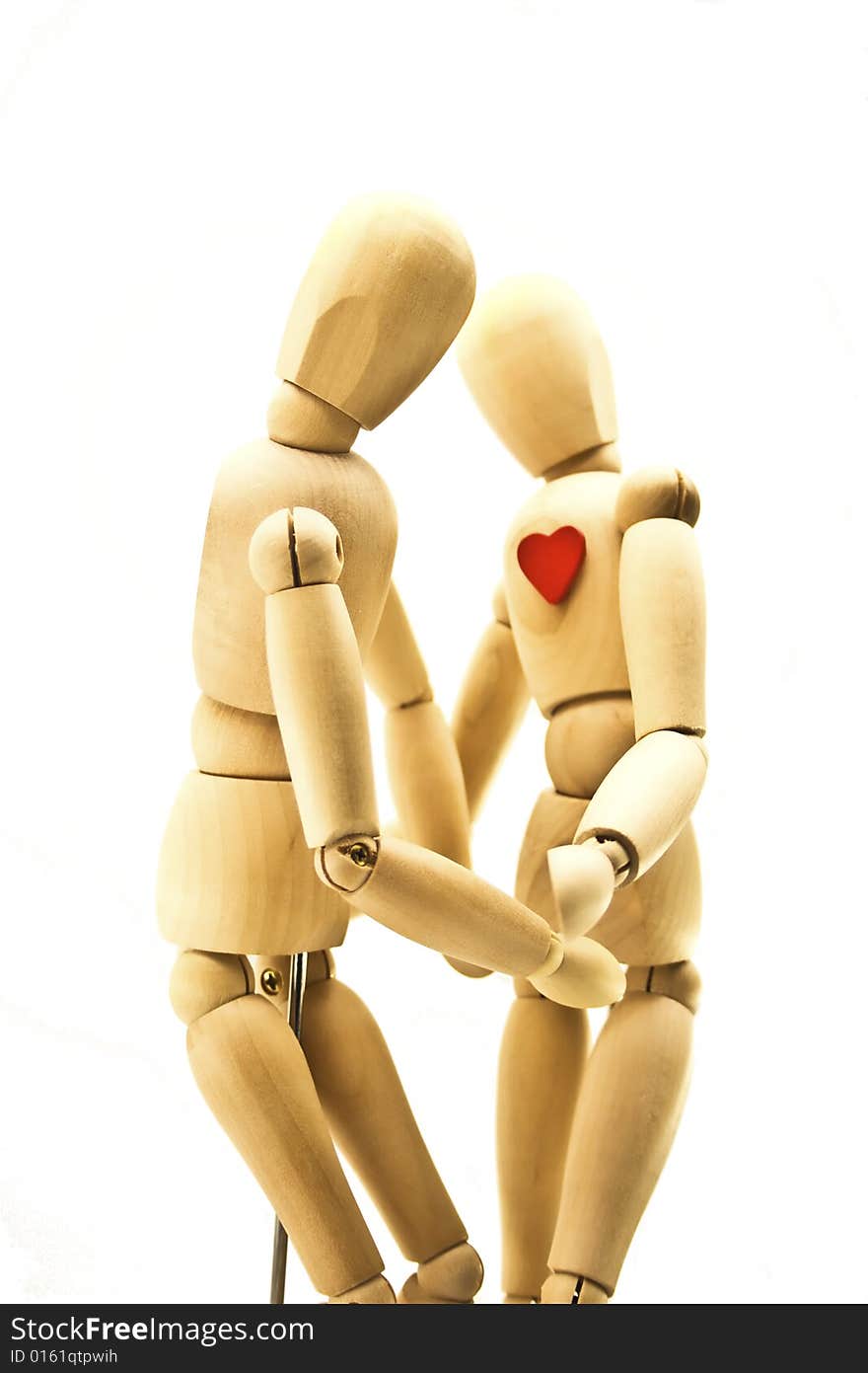 Loving couple of wooden dummies isolated on a white background