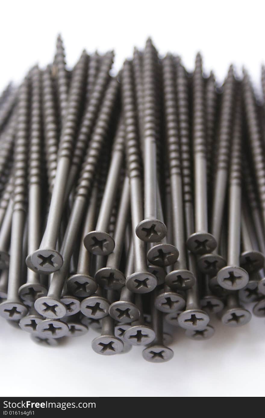 Sundries. Group of iron screws on a white background