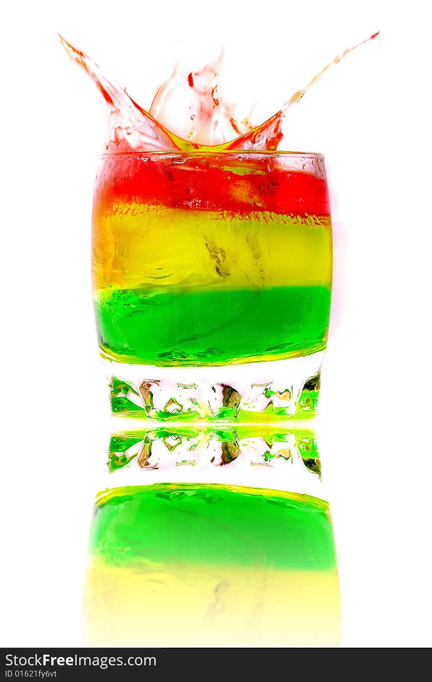 Ice falls in a glass with a colored cocktail. Ice falls in a glass with a colored cocktail