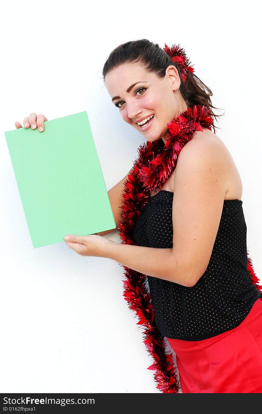 Beautiful woman holding a green card for Christmas. Beautiful woman holding a green card for Christmas.