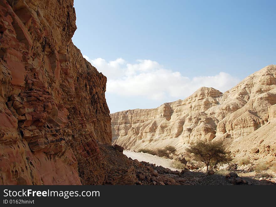 The dried up channel of the river in Judaic mountains near to the Dead Sea. The dried up channel of the river in Judaic mountains near to the Dead Sea