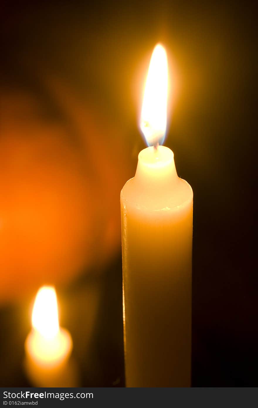 Candles and pumpkin on black background