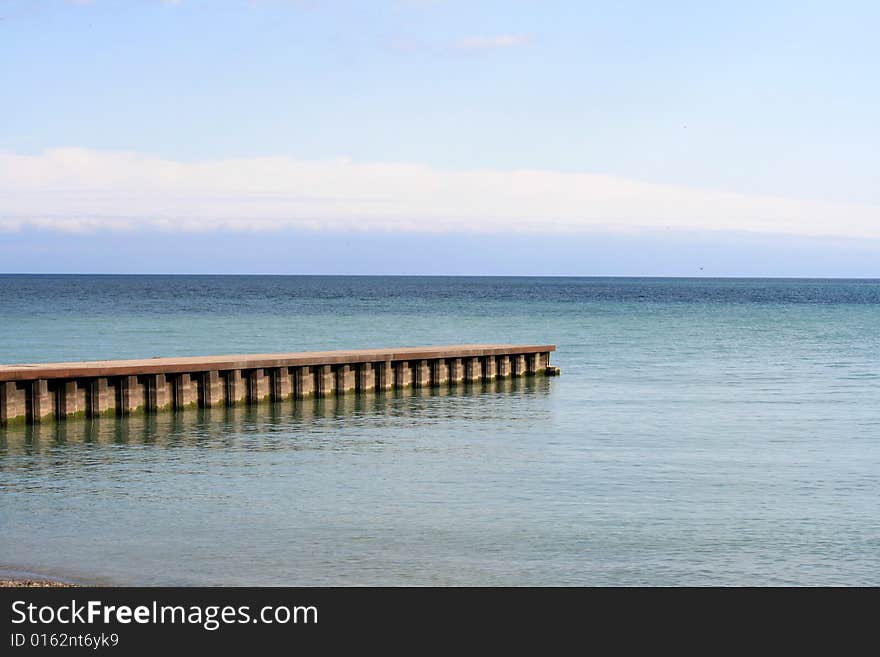 Sea and sky landscape with pier. Sea and sky landscape with pier