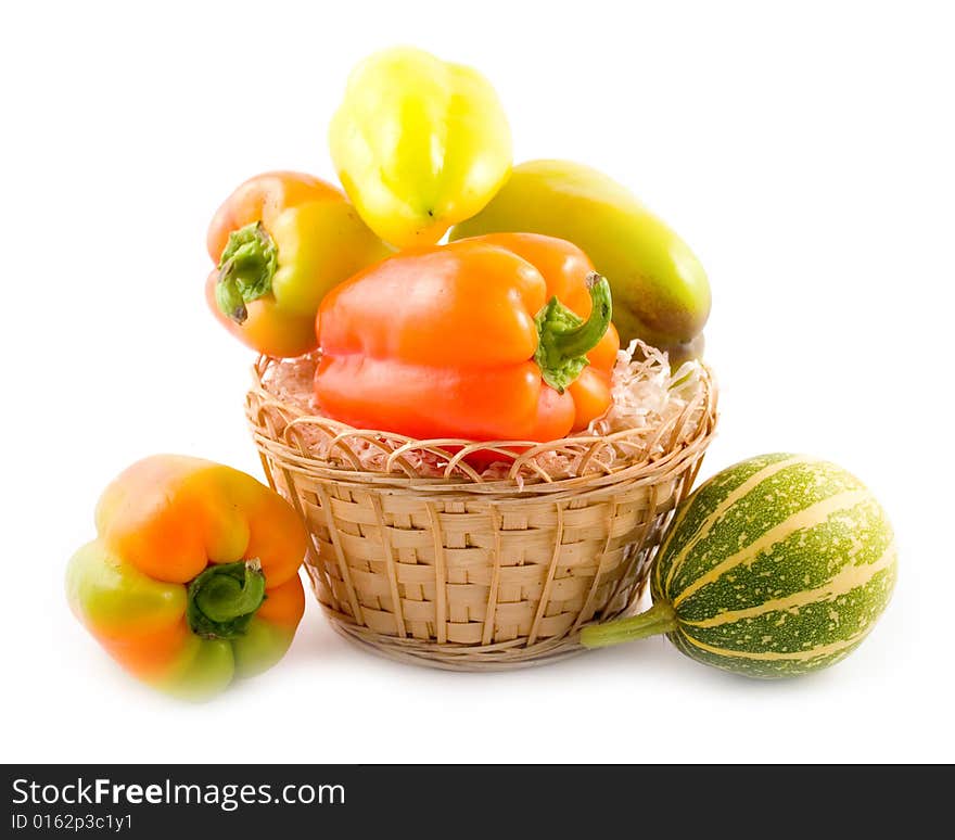 Sweet beautiful pepper decorative pumpkin in basket on white background. Sweet beautiful pepper decorative pumpkin in basket on white background