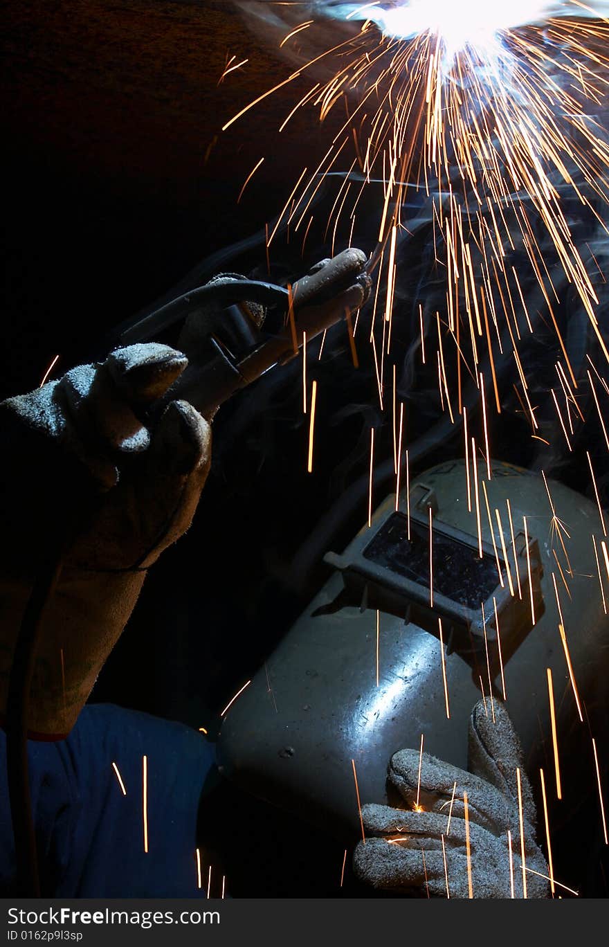 A welder working at shipyard at night. A welder working at shipyard at night