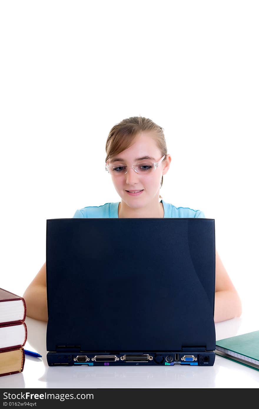 Happy smiling teenager girl on desk doing studying and homework