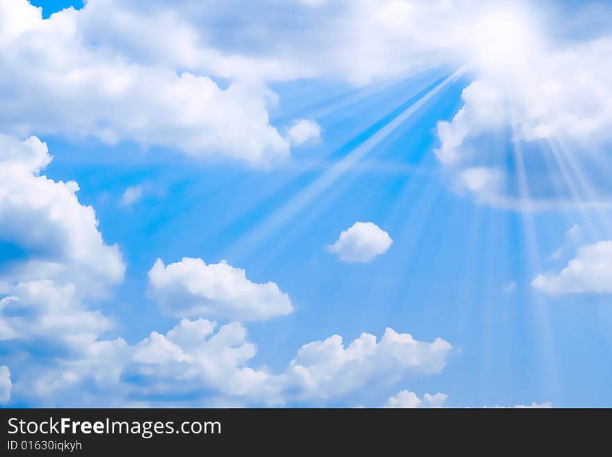 Bright sunbeams illuminate beautiful cloud on blue sky