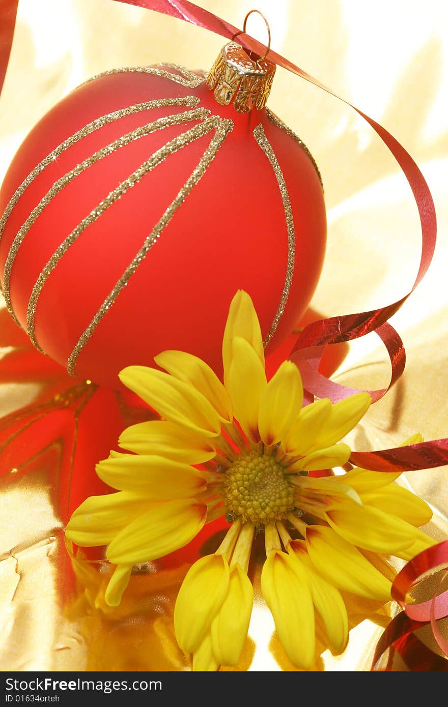 Christmas red ball with yellow flower on golden background. Christmas red ball with yellow flower on golden background.