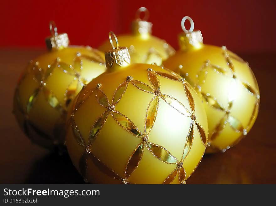 Close-up of golden glass balls on red background. Close-up of golden glass balls on red background