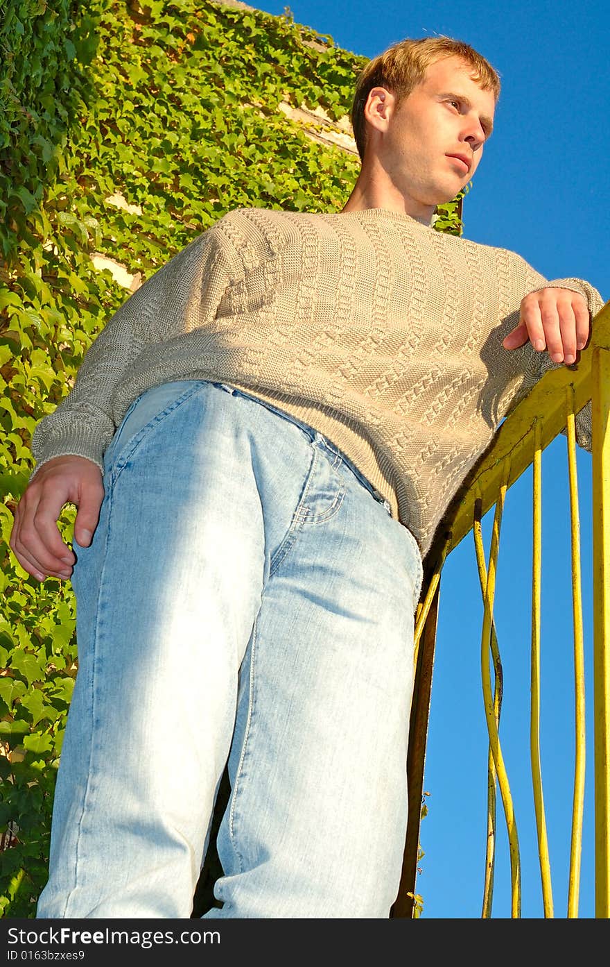 Young Stylish Man Near Overgrown Wall.