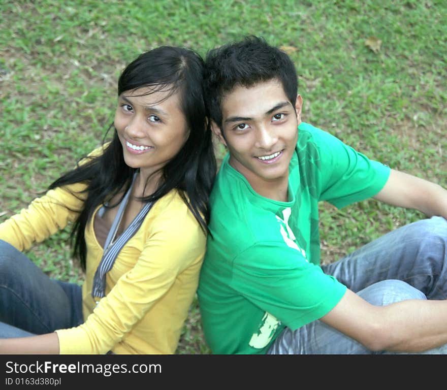 Happy asian couple on the grass