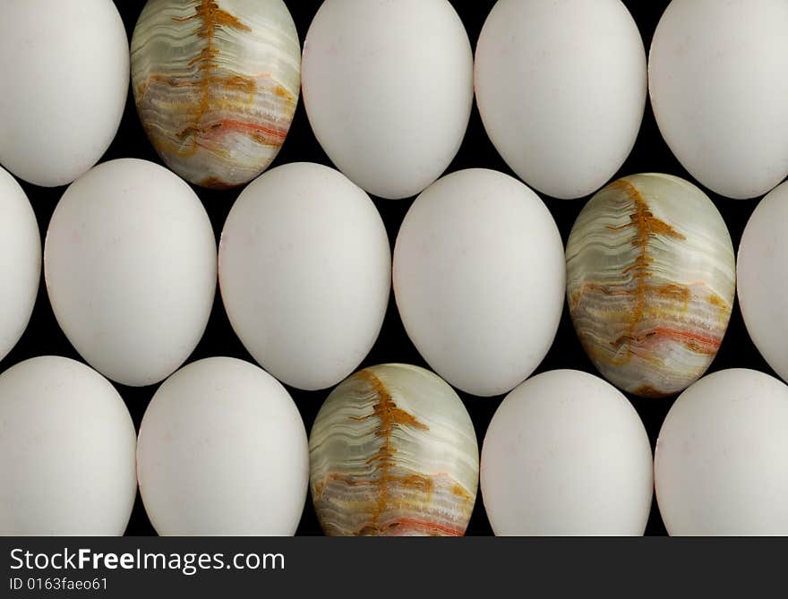 Three gem eggs among white chicken eggs. Three gem eggs among white chicken eggs