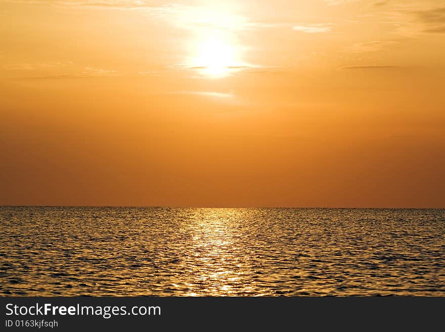 Orange sunset above a quiet serene gulf