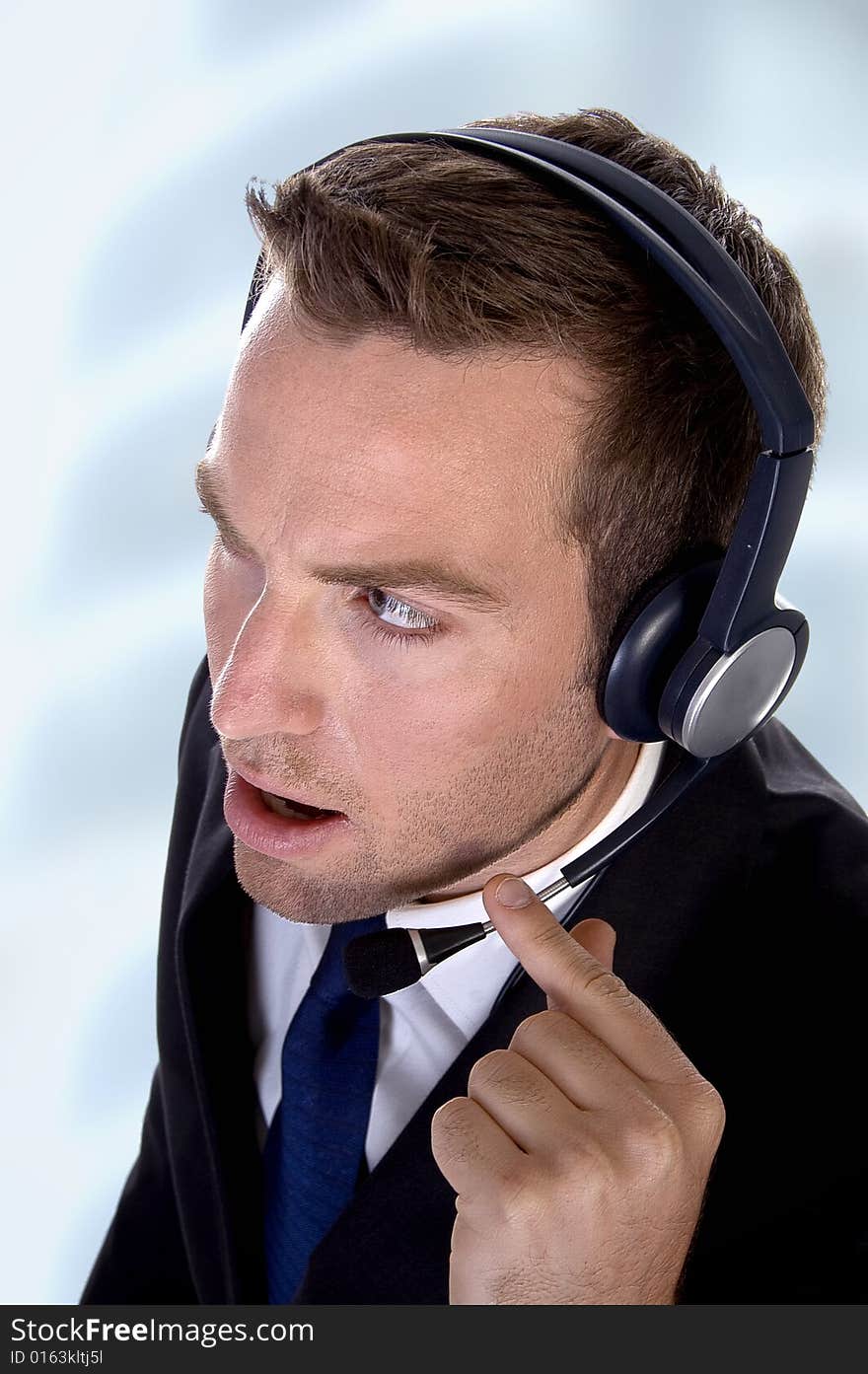 Potrait young businessman with headphones on an abstract background