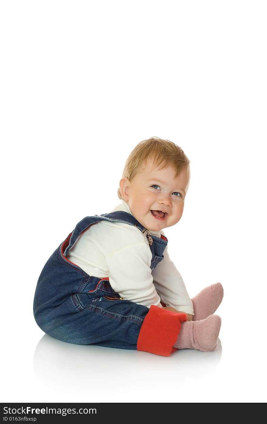 Small smiling baby in blue jeans isolated