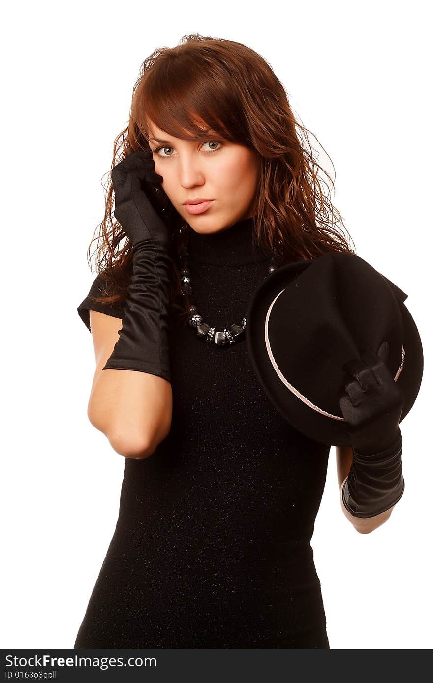 The girl in black clothes on a white background with a hat hat