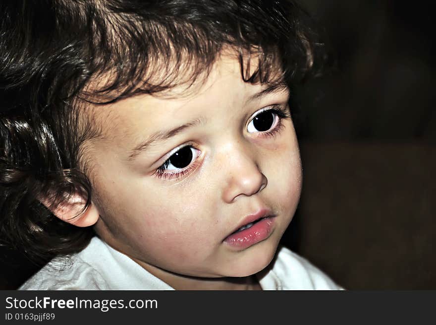 Little girl with big brown eyes and curly hair close-up. Little girl with big brown eyes and curly hair close-up