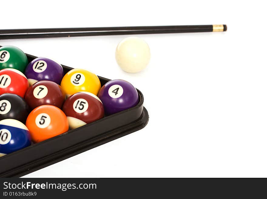 Billiard balls arranged in a triangle and a cue on a white background