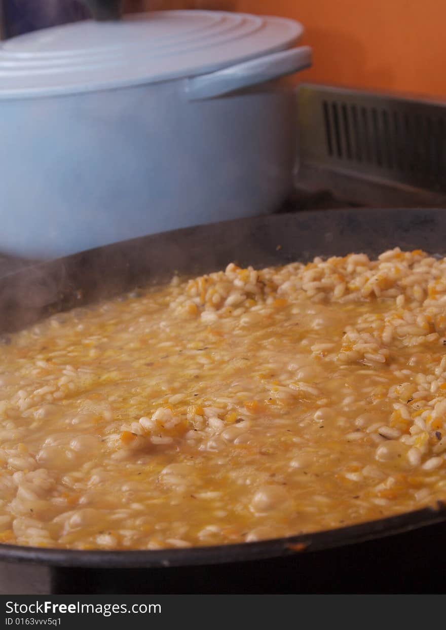 Vegetable risotto bubbling in a pan. Vegetable risotto bubbling in a pan.