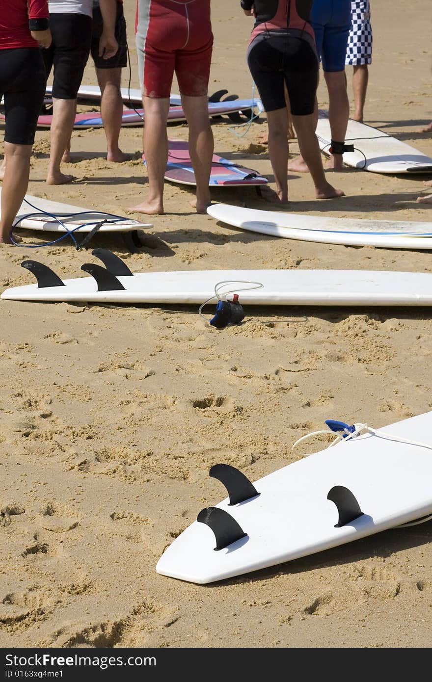 Surfers on the Beach with their Boards