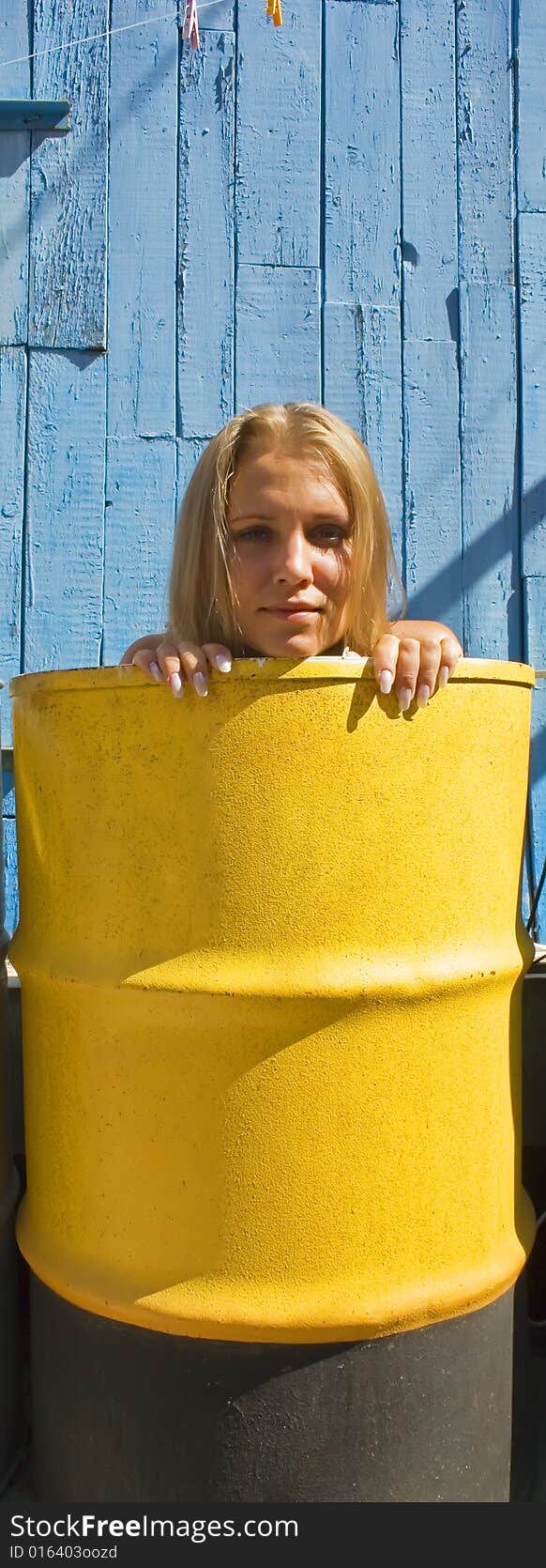 The beautiful girl relaxes in a barrel. The beautiful girl relaxes in a barrel