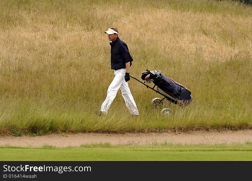 Golf player walking with his club bag. Golf player walking with his club bag