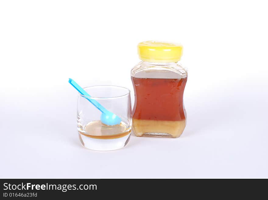 Honey bottle on white background