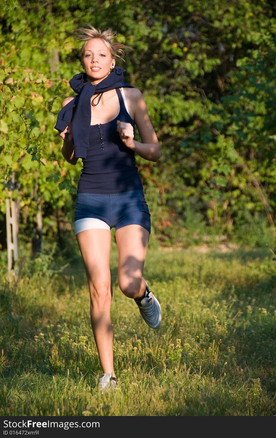 Girl jogging among beautiful vineyards