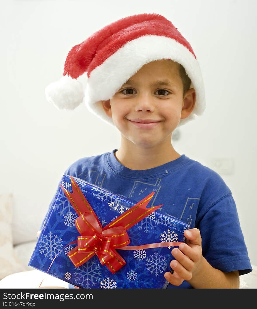 Young boy with Christmas hat and presents. Young boy with Christmas hat and presents