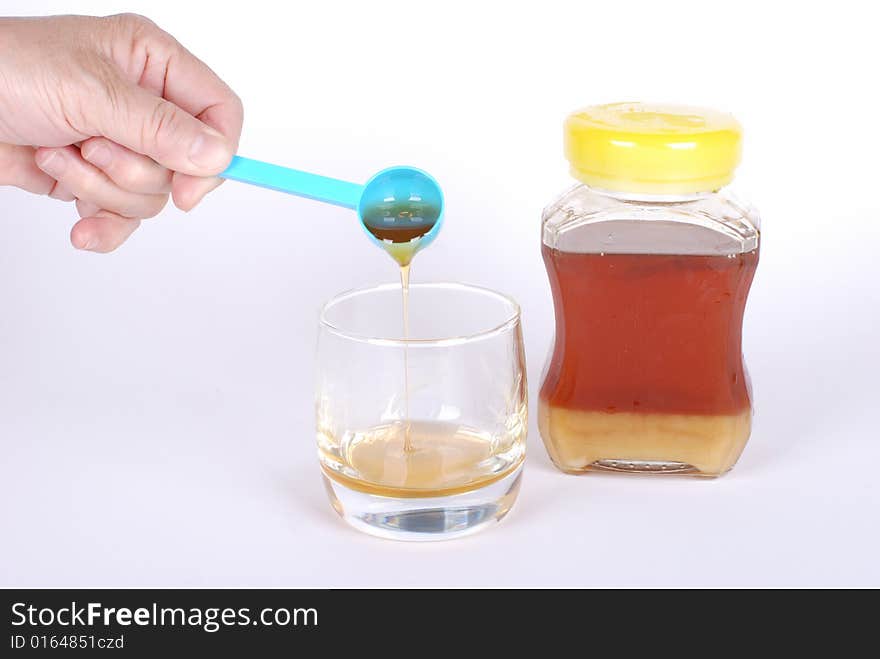 Honey bottle on white background