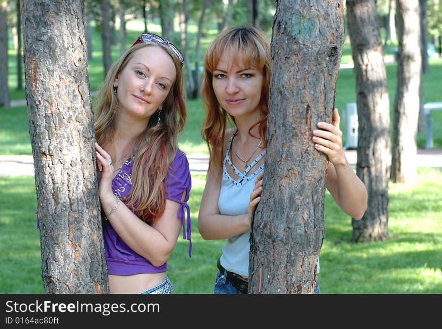 Girl staying near the tree in the park. Girl staying near the tree in the park.