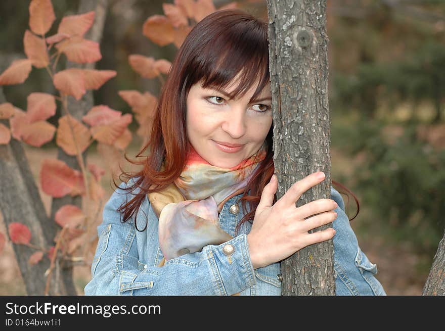 Girl staying near the tree and smiling. Girl staying near the tree and smiling.