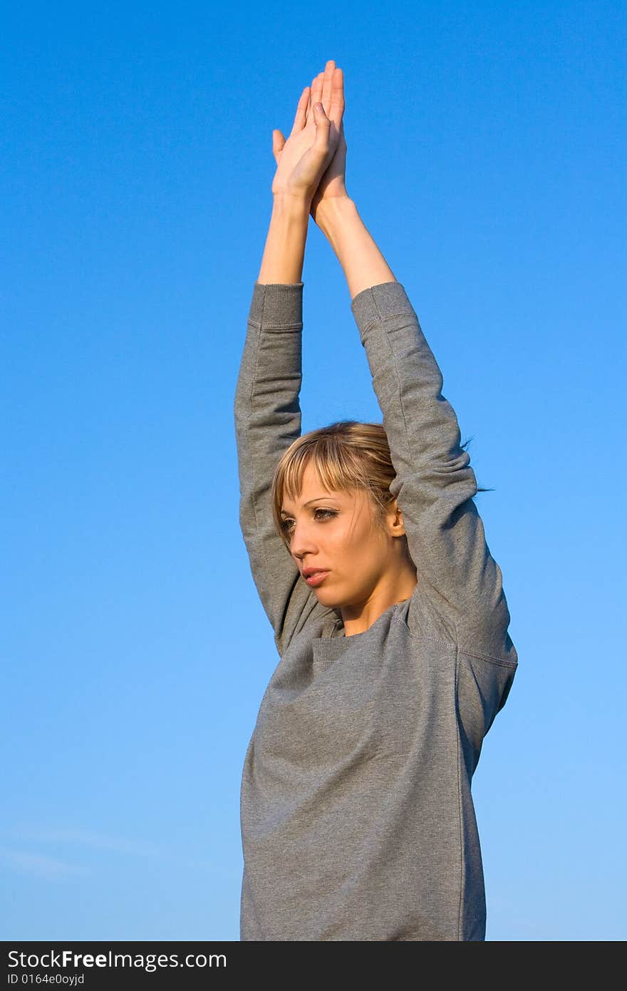 Young woman spreading arms to  blue sky