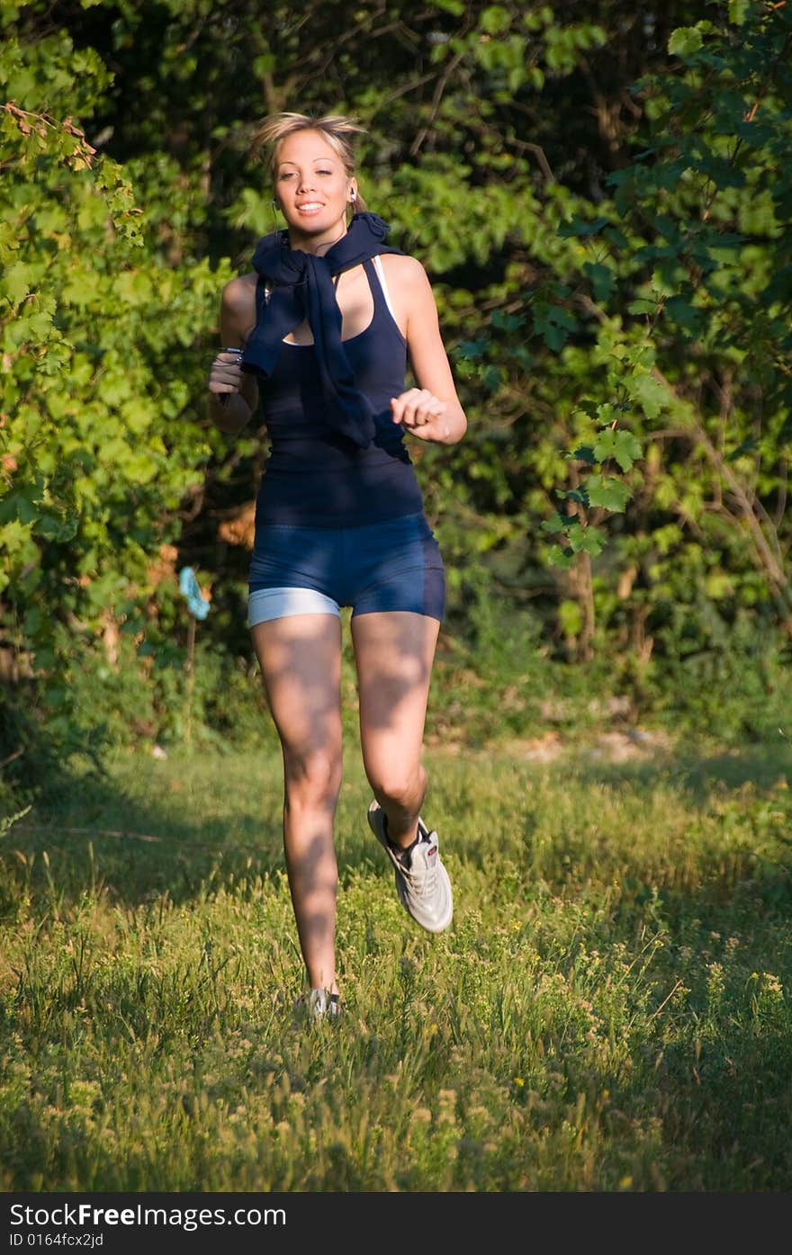 Girl jogging among beautiful vineyards