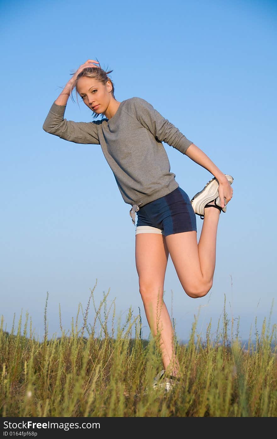 Athletics young woman stretching