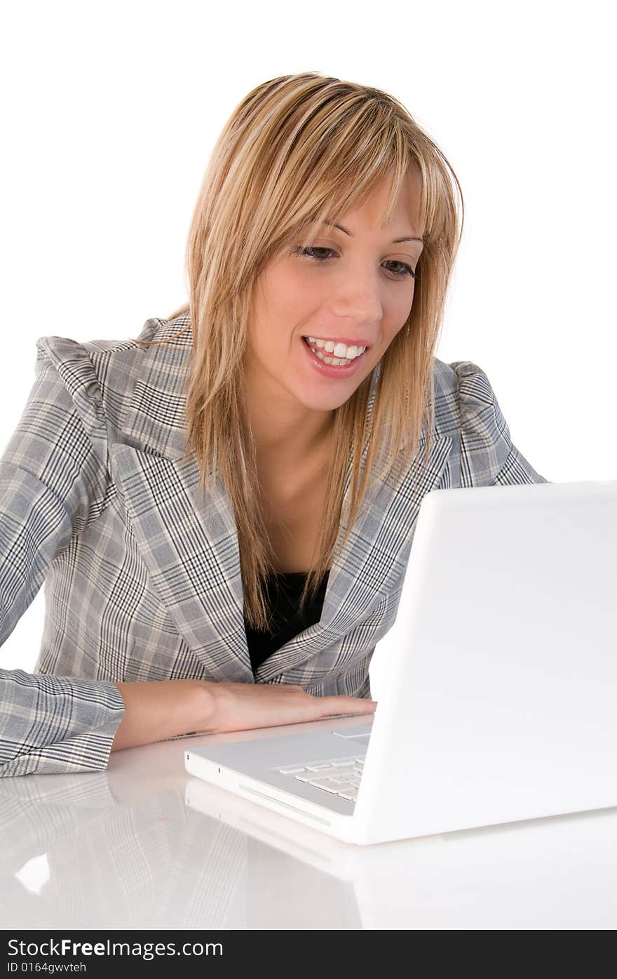 Portrait of confident business woman sitting at the table and typing a document on the laptop. Portrait of confident business woman sitting at the table and typing a document on the laptop