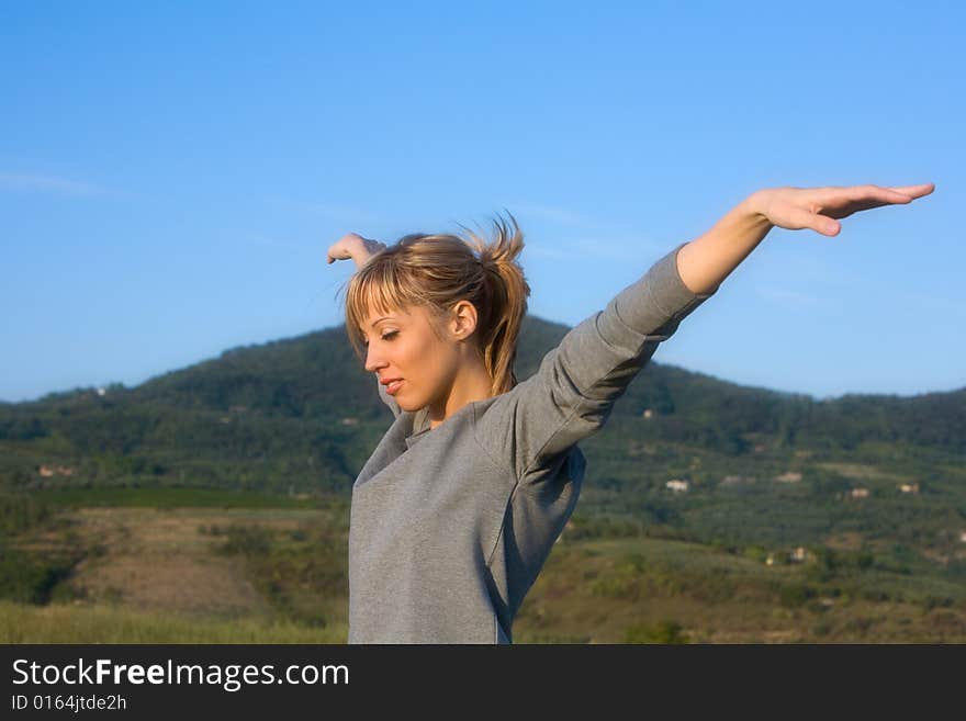 Young woman spreading arms to  blue sky