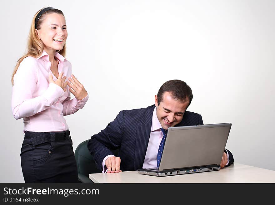 Emotional discussion. Businessman is working on laptop and discussing something with his female assistant