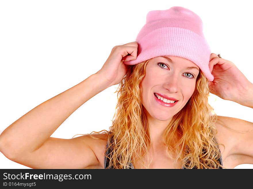 Young woman trying on a pink knit hat