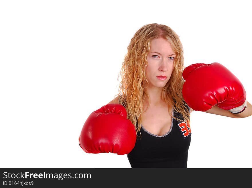 Attractive blonde woman wearing boxing gloves in a fighting pose